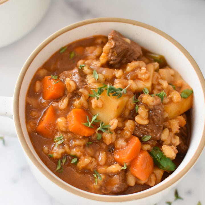 Slow Cooker Beef Barley Soup in a white bowl