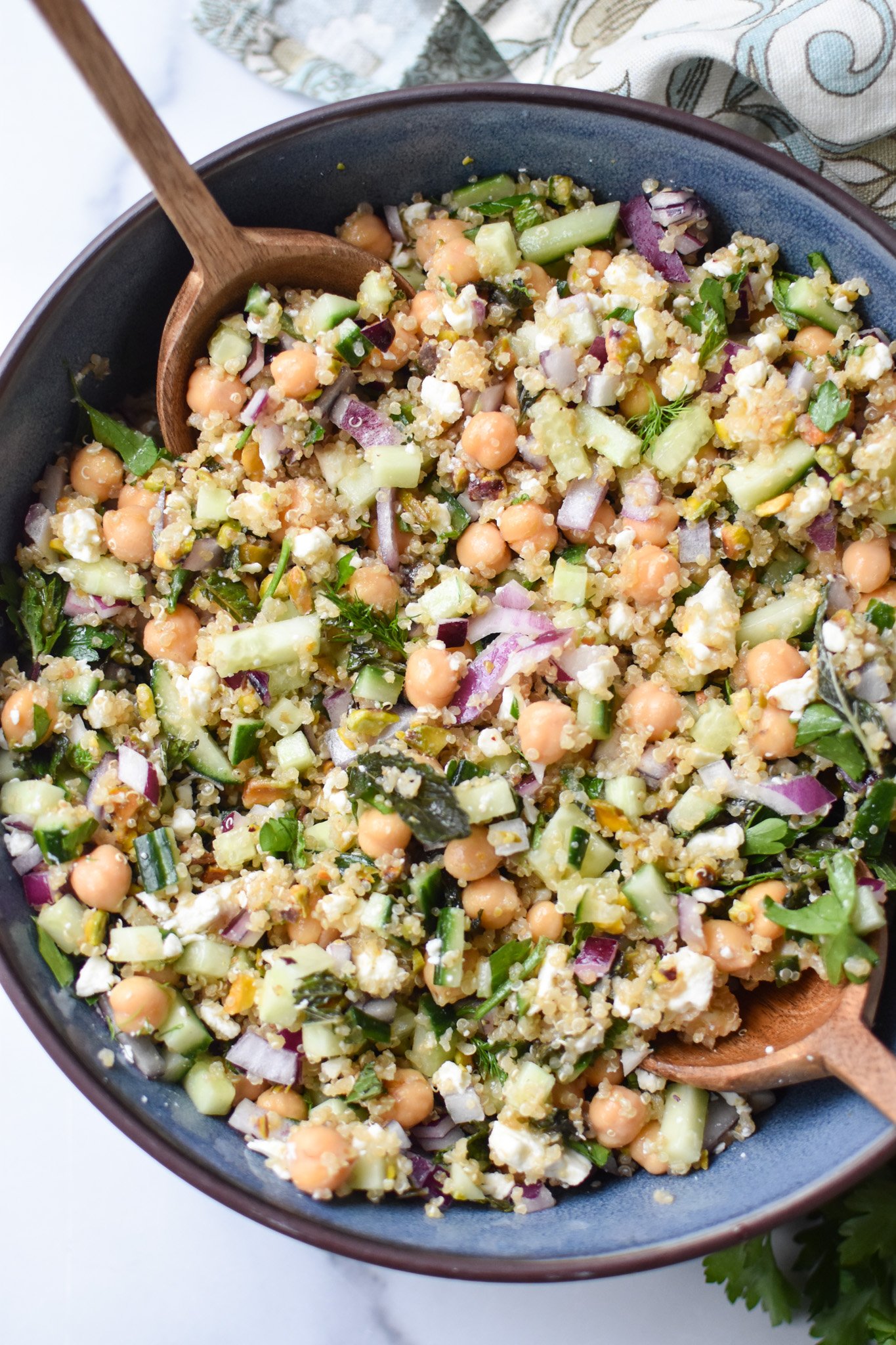salad ingredients mixed in a blue bowl.