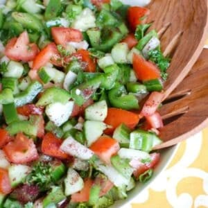 Easy Lebanese Salad in white bowl with wooden spoons