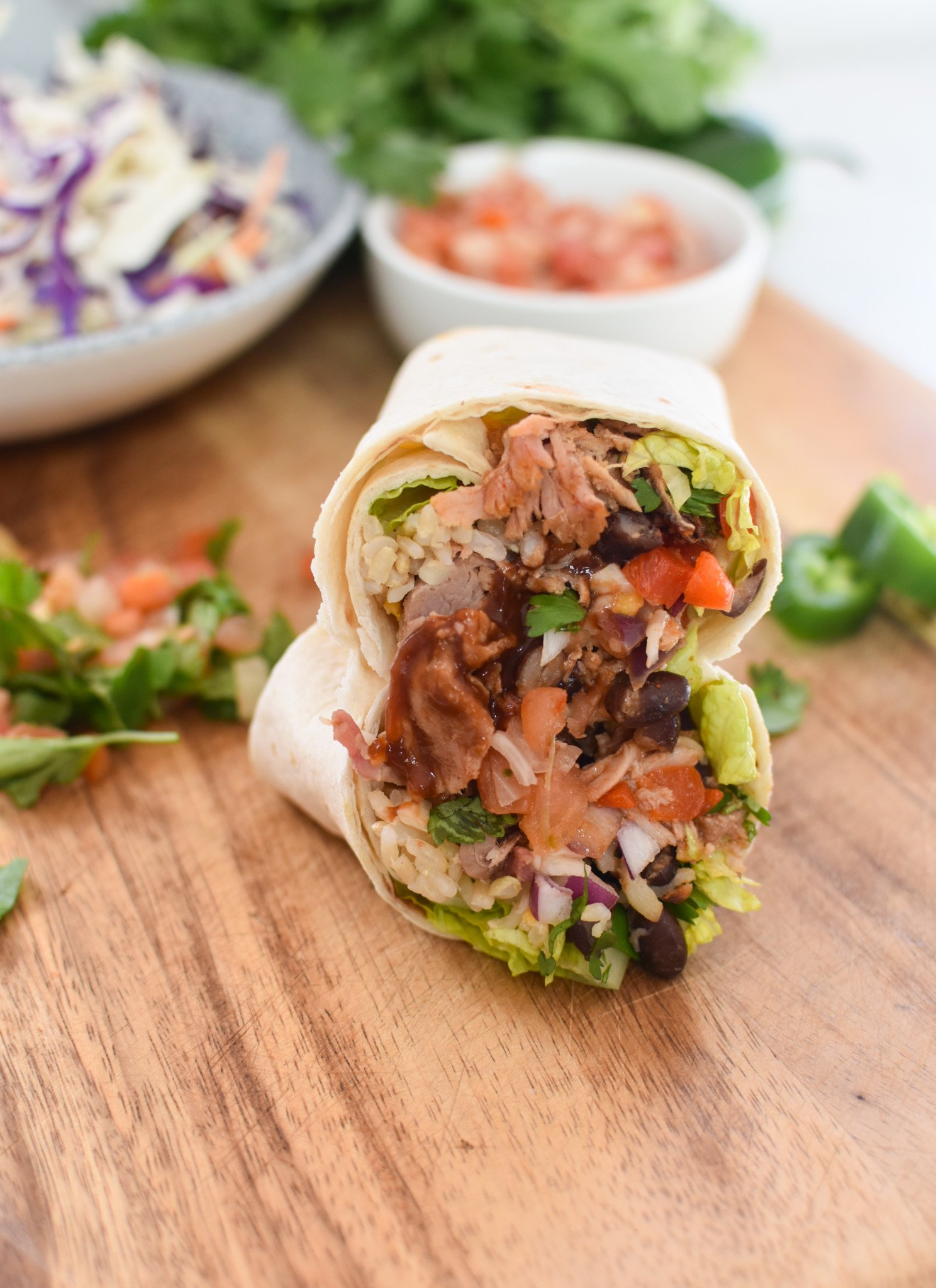 Pulled Pork Burritos on a cutting board 