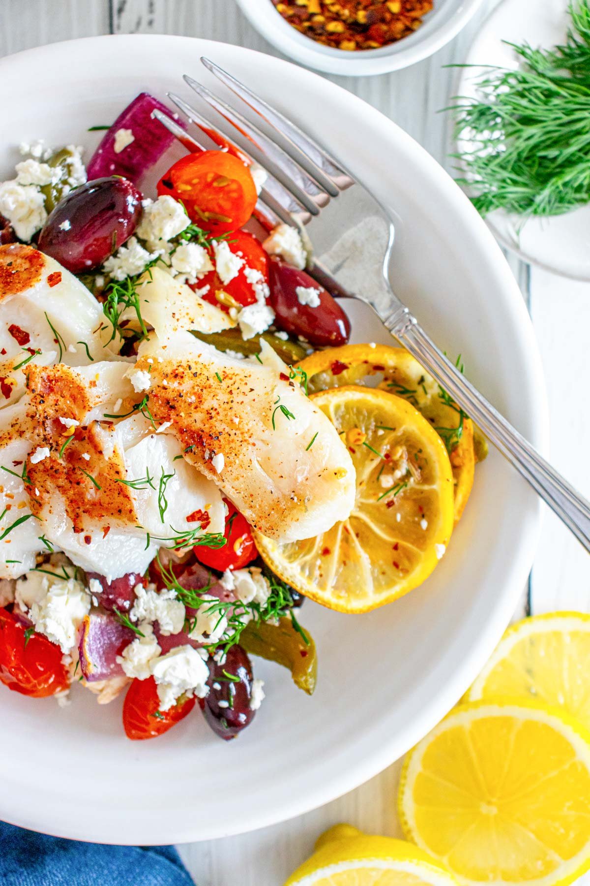 Sheet Pan Mediterranean Cod with fork in a bowl 