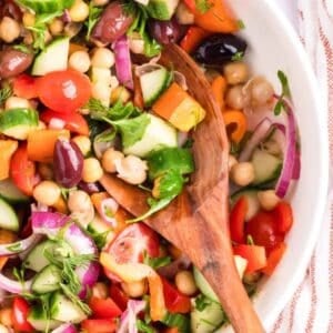 Mediterranean Chickpea Salad in a white bowl with spoon