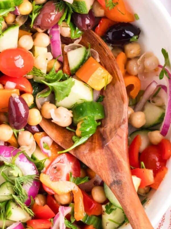 Mediterranean Chickpea Salad in a white bowl with spoon