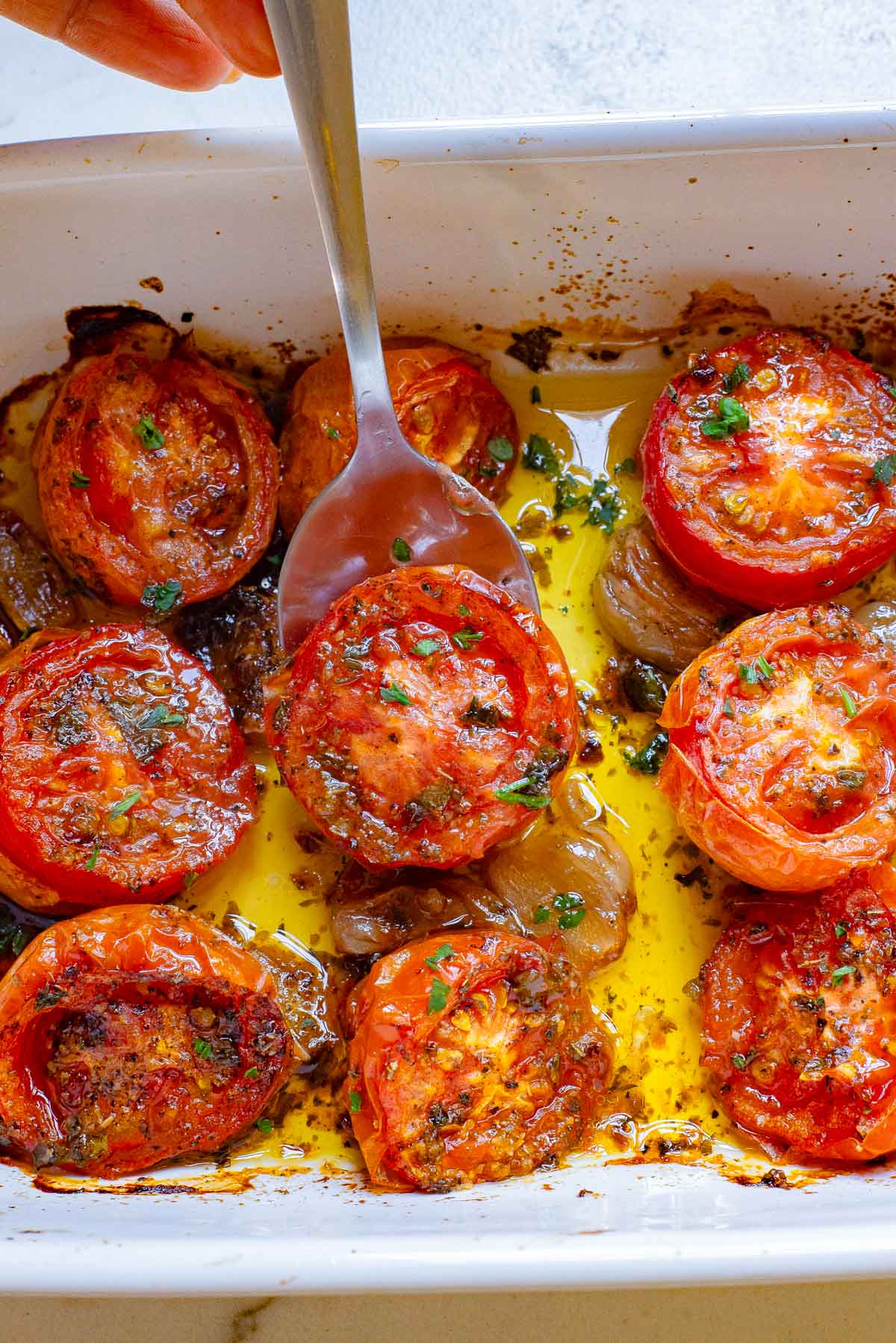 Oven Roasted Tomatoes with fork in pan 