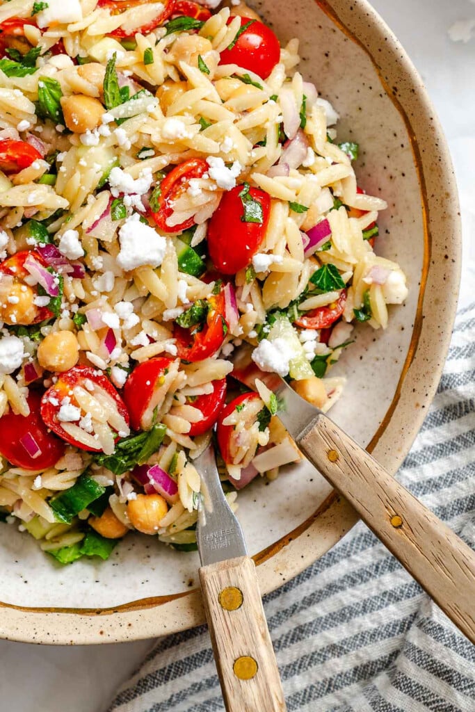 Summer Orzo Pasta Salad in a bowl with two spoons 