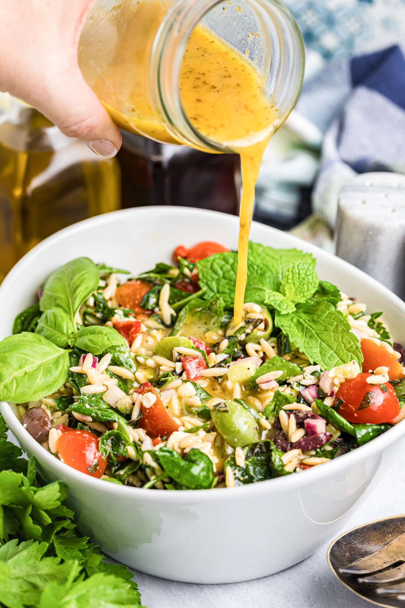 Mediterranean Pasta Salad dressing being poured 