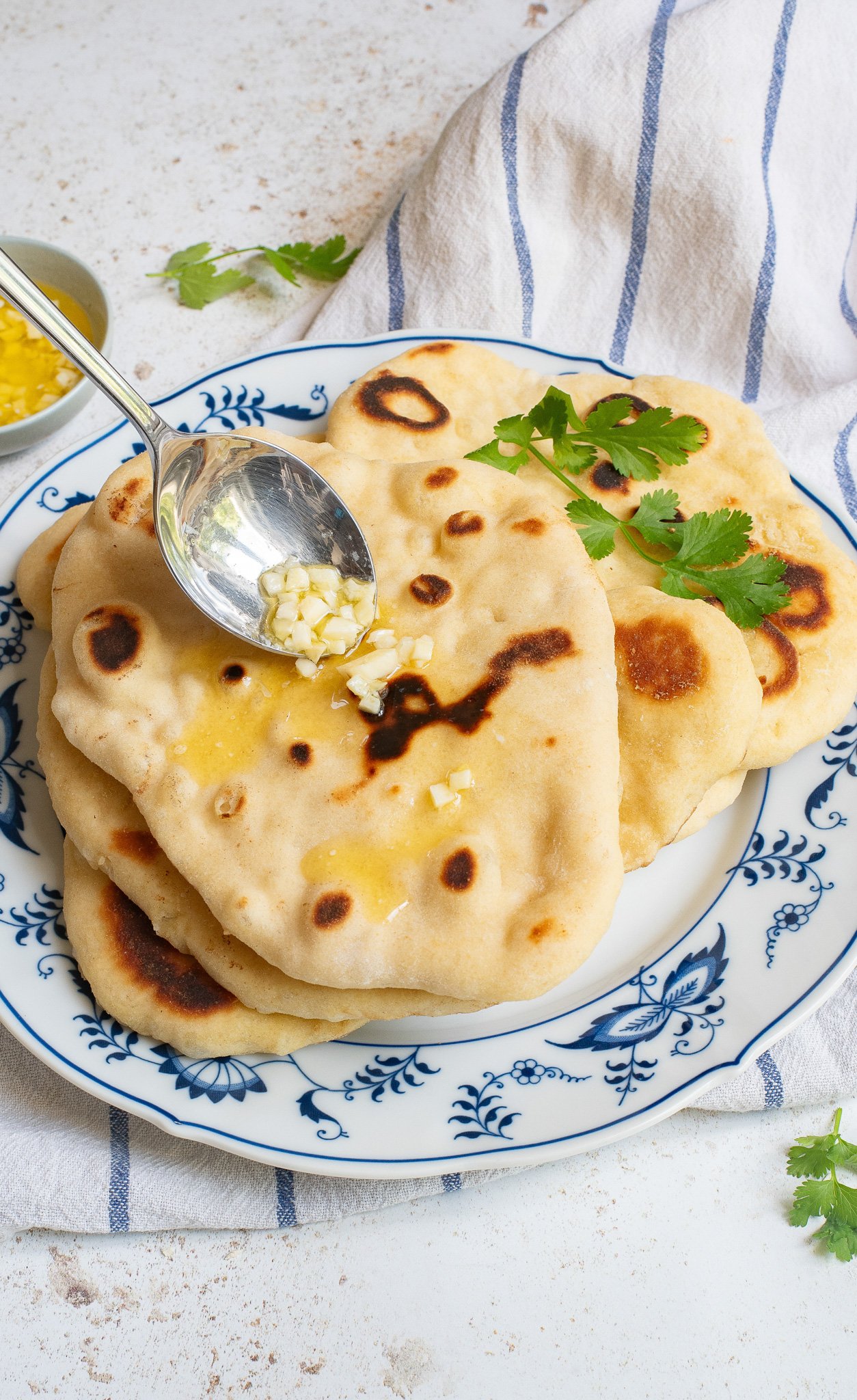 Easy Homemade Naan garlic going on naan bread 