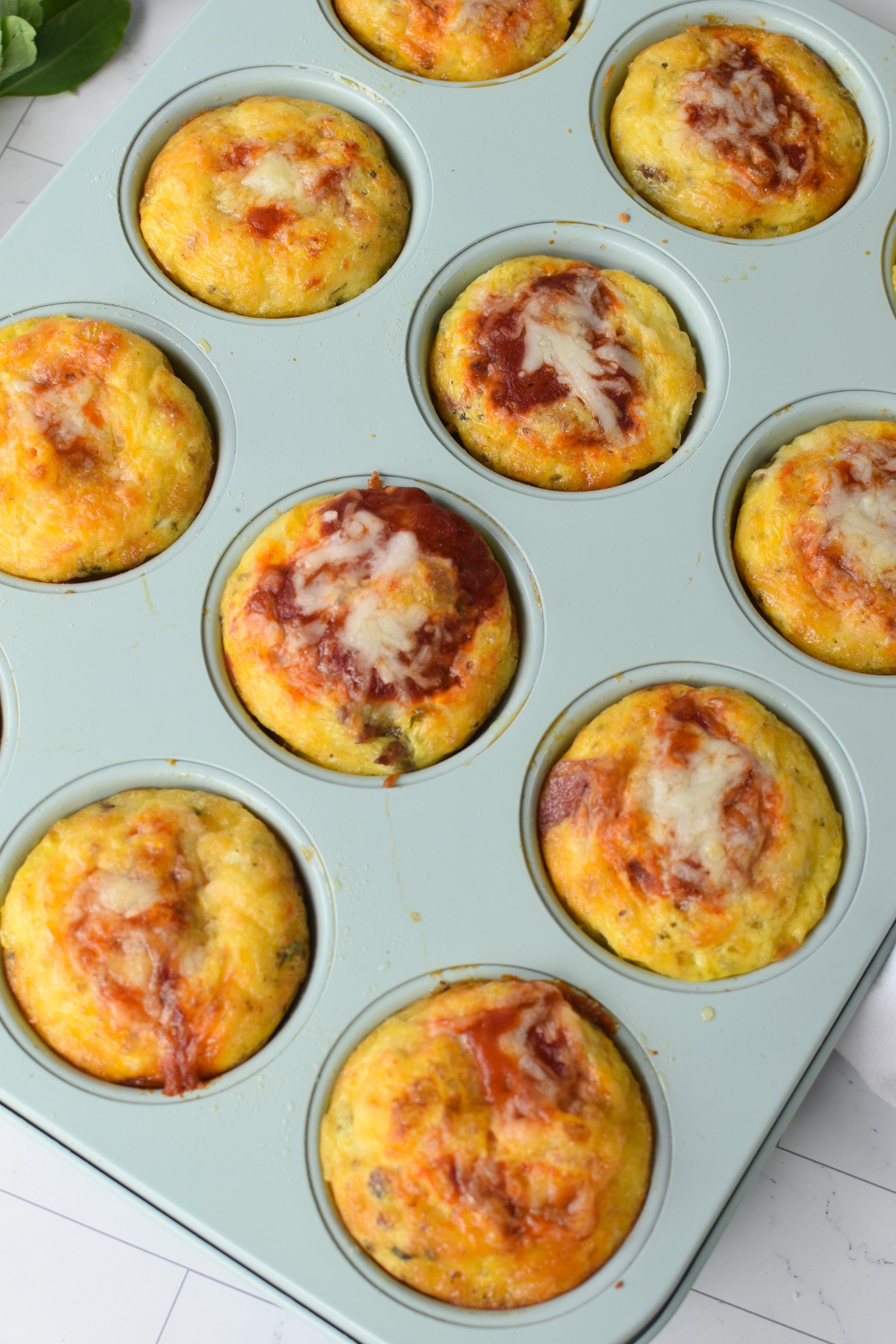 Pizza Egg Muffins in blue muffin tin