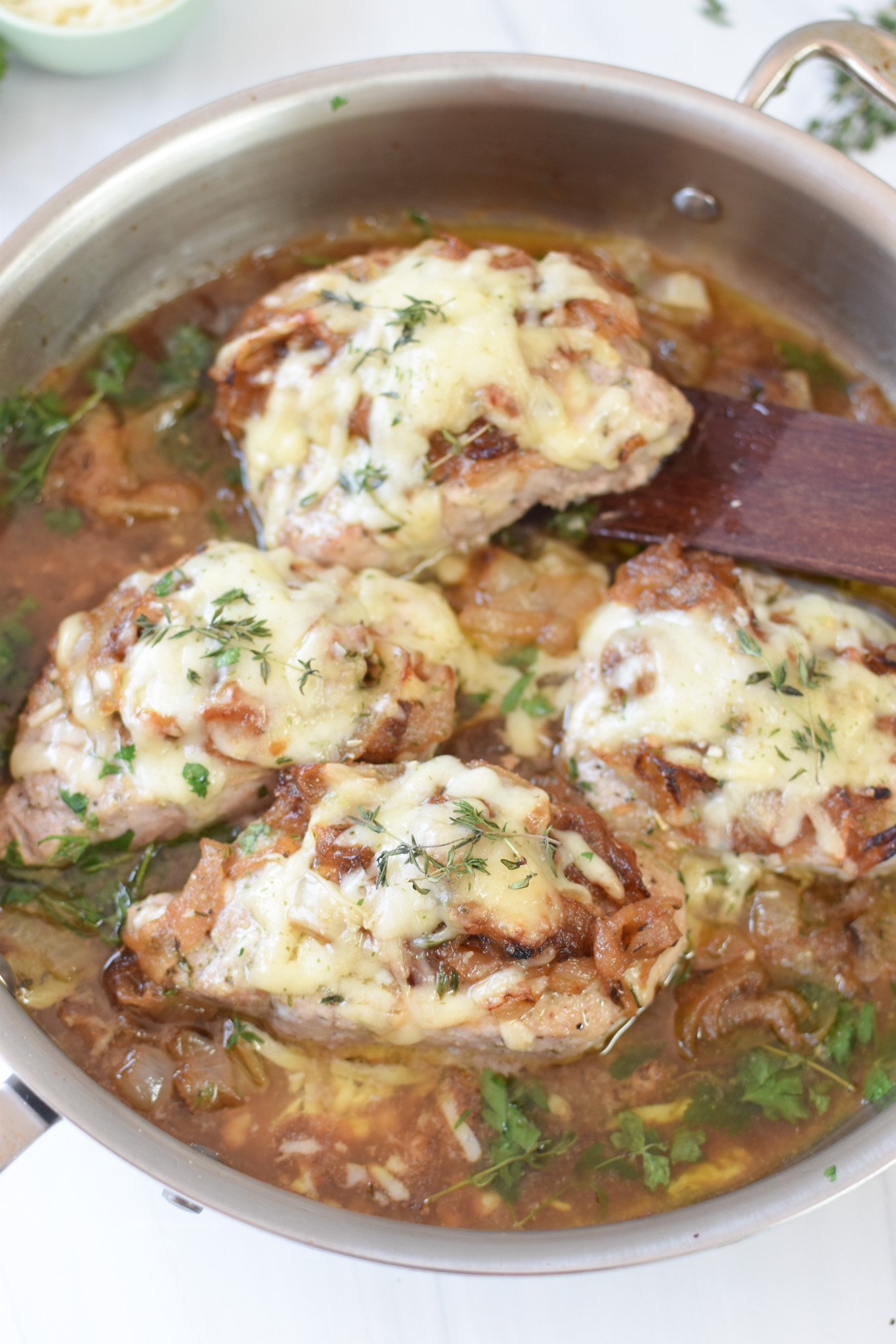French Onion Pork Chops with a wooden spatula 