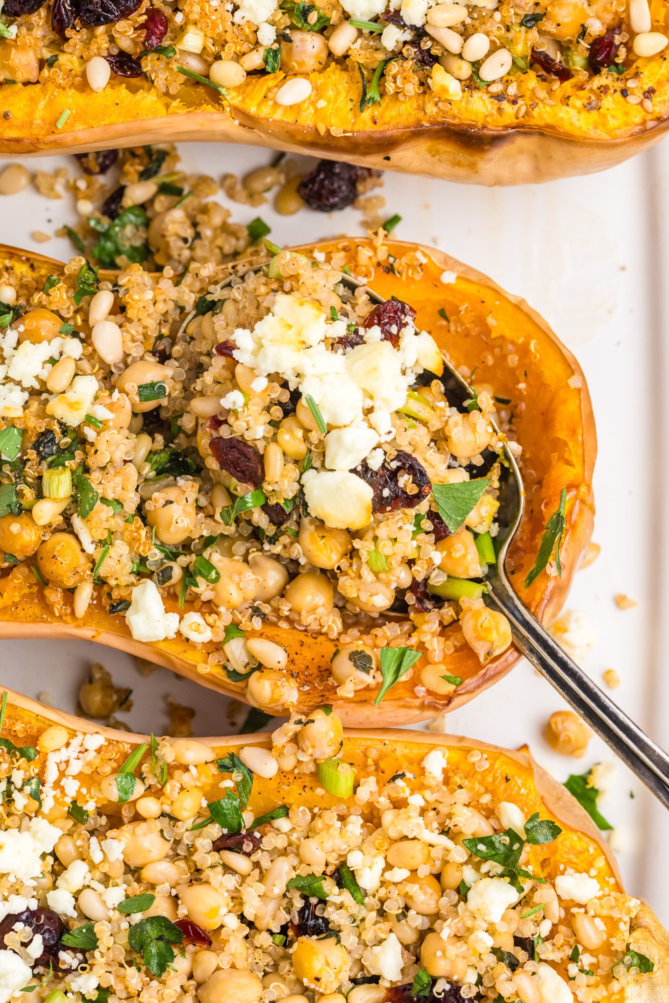 Mediterranean Stuffed Butternut Squash with a spoon and feta cheese