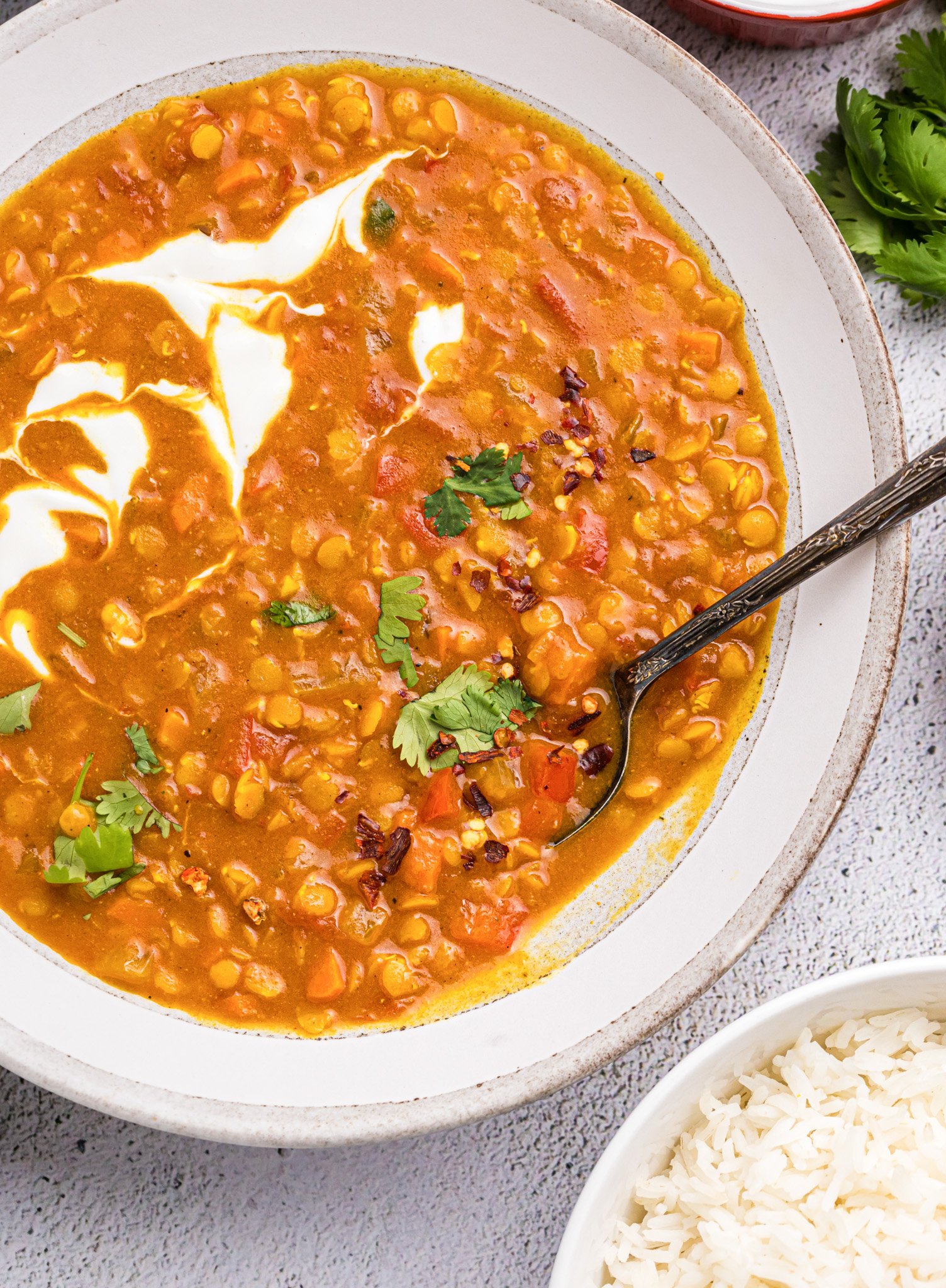 Easy Red Lentil Dahl Recipe with spoon and Greek yogurt 