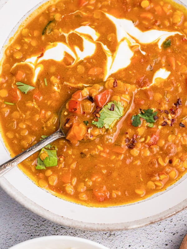 Easy Red Lentil Dahl Recipe in a bowl with Greek yogurt