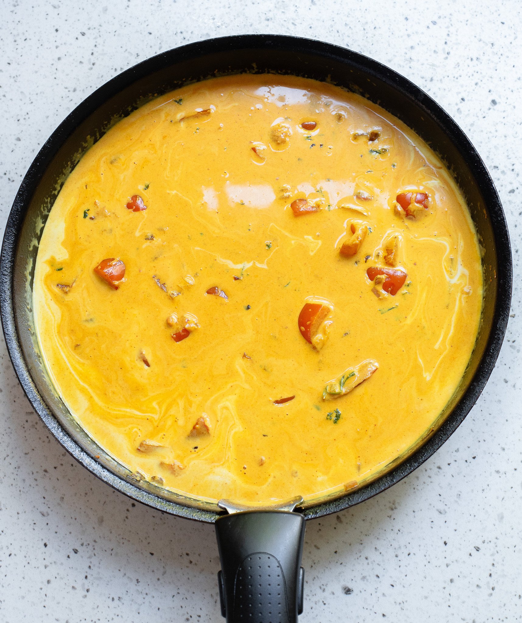 Coconut Fish Curry in a black skillet 