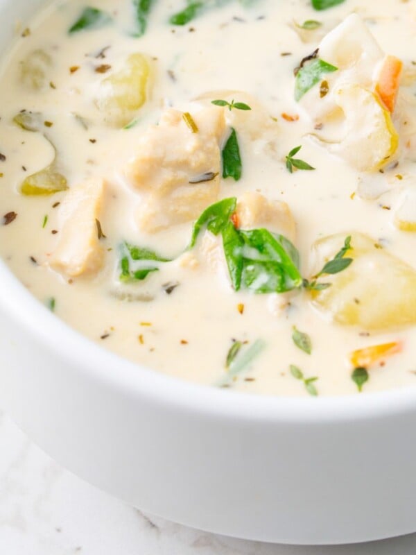 Copycat Olive Garden Chicken Gnocchi Soup in a white bowl up close