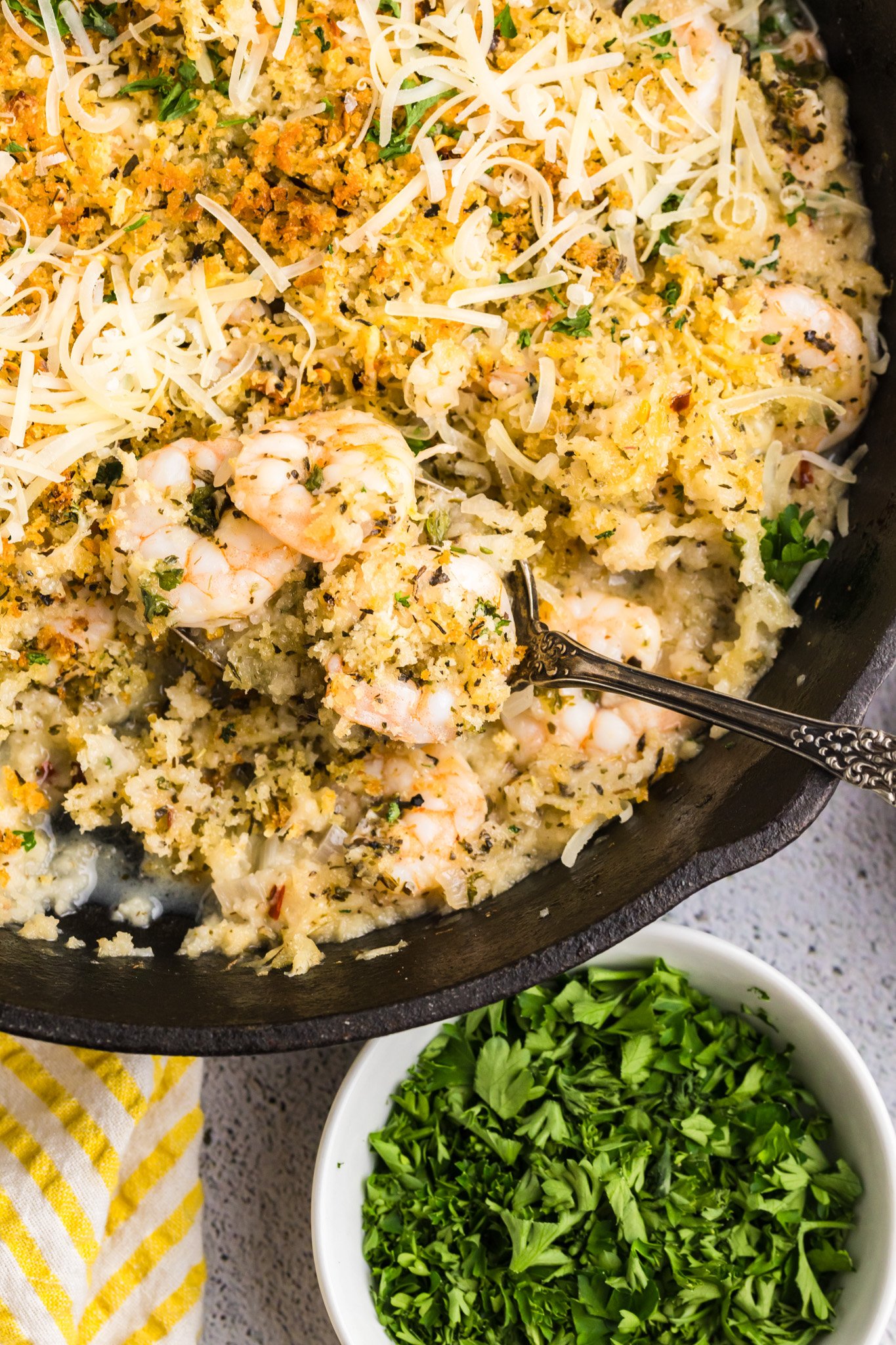 Easy Breaded Shrimp in a cast iron skillet with a spoon 