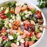Mediterranean Salmon Bowl in a white bowl with a gold fork