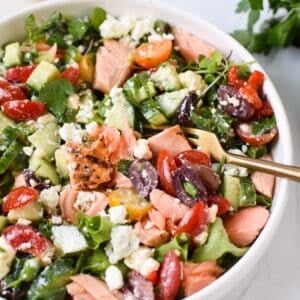 Mediterranean Salmon Bowl in a white bowl with a gold fork