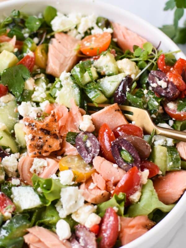 Mediterranean Salmon Bowl in a white bowl with a gold fork