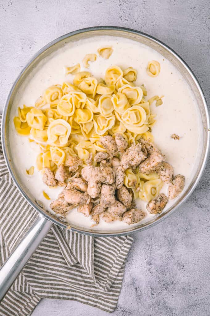 Olive Garden Chicken Tortellini Alfredo tortellini and chicken in pan