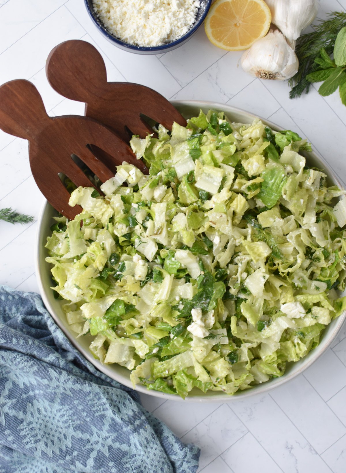 Maroulosalata with wooden serving utensils 