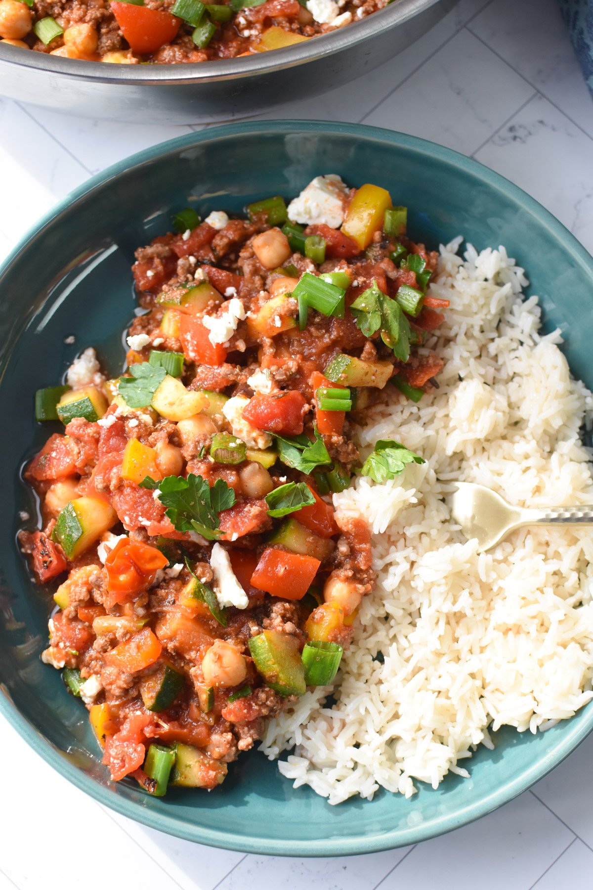 Mediterranean Ground Beef Skillet in a bowl with a fork