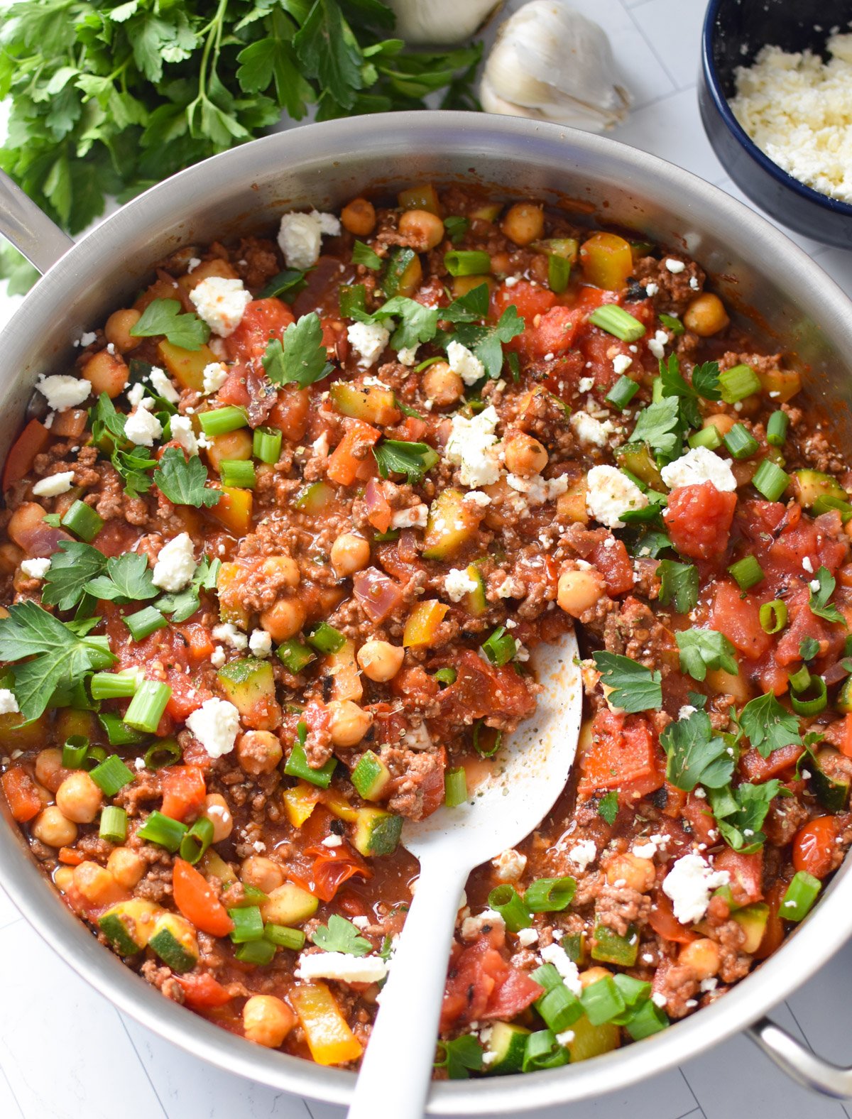 Mediterranean Ground Beef Skillet with a white spoon 