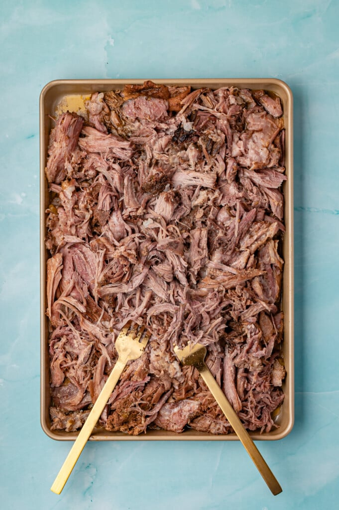 Slow Cooker Shredded Pork Tacos shredded on a baking sheet
