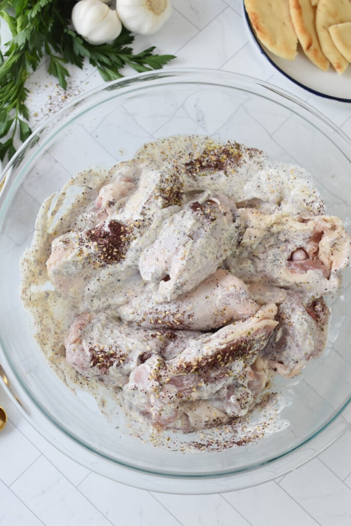 Sheet Pan Za’atar Chicken marinading in a bowl 