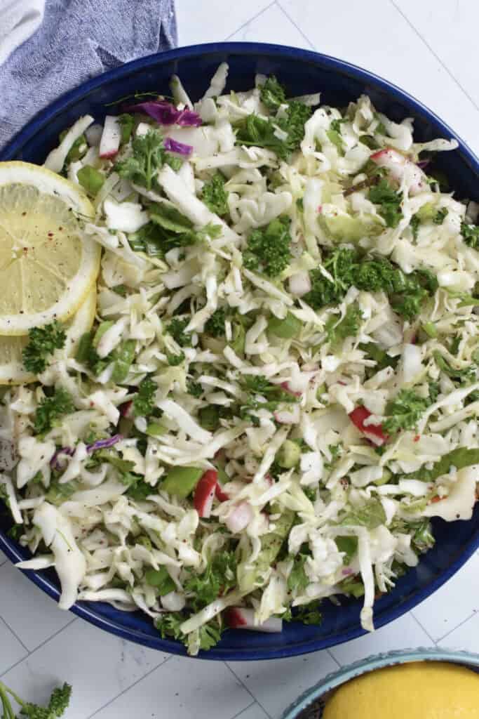 Malfouf Salad in a blue bowl with a lemon slice