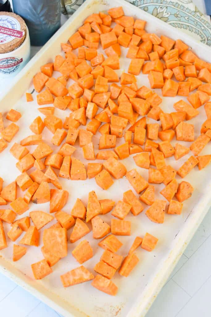 Sweet Potato Cottage Cheese Bowls with sweet potatoes roasting on a pan