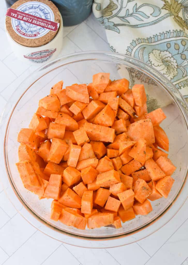 Sweet Potato Cottage Cheese Bowls sweet potatoes with olive oil and spices in a glass bowl