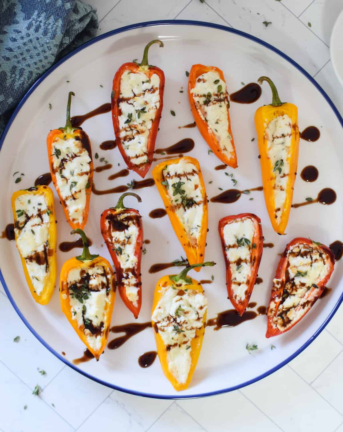 Goat Cheese Stuffed Mini Peppers on a white and blue plate