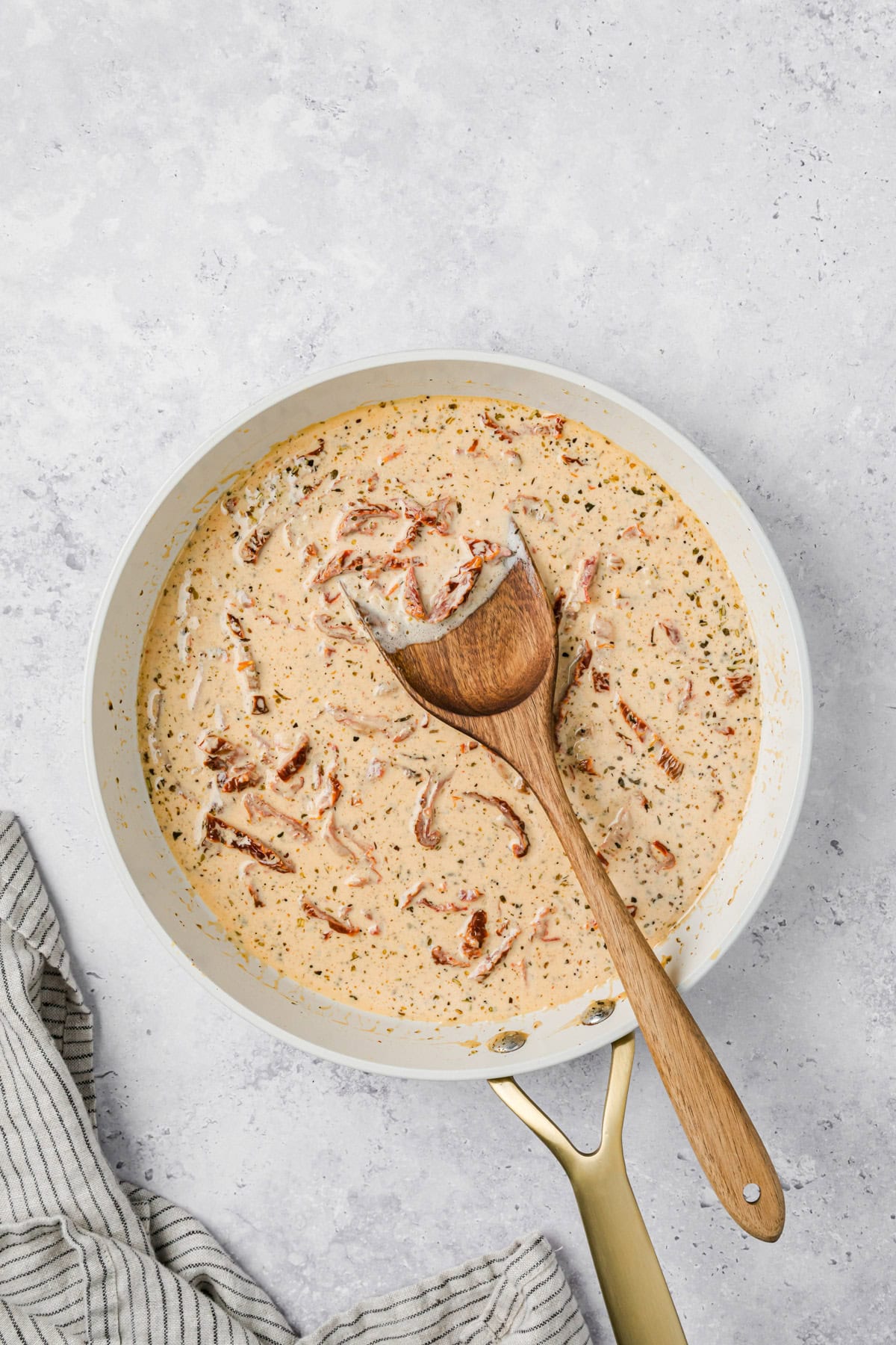 Marry Me Sauce in a skillet with a spoon