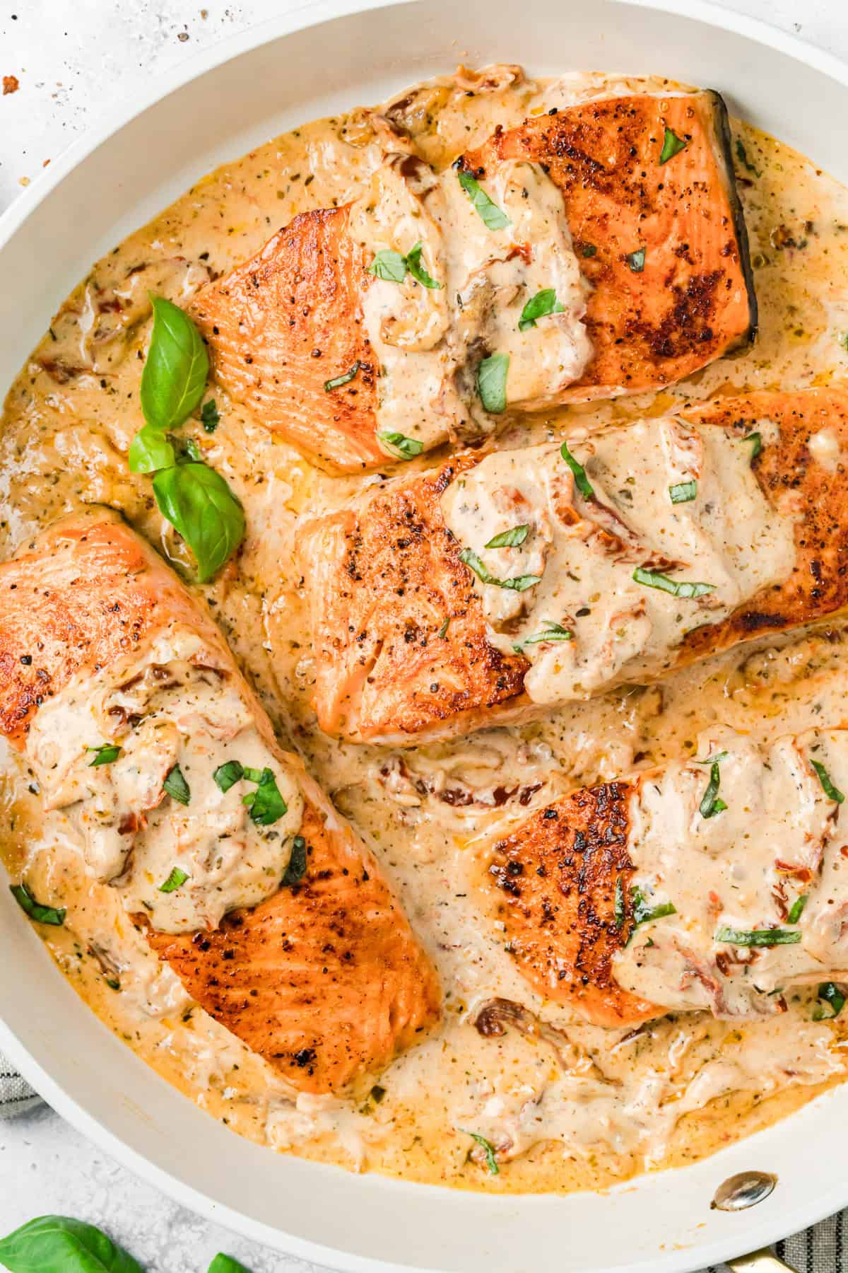 Marry Me Salmon Recipe in a skillet with basil
