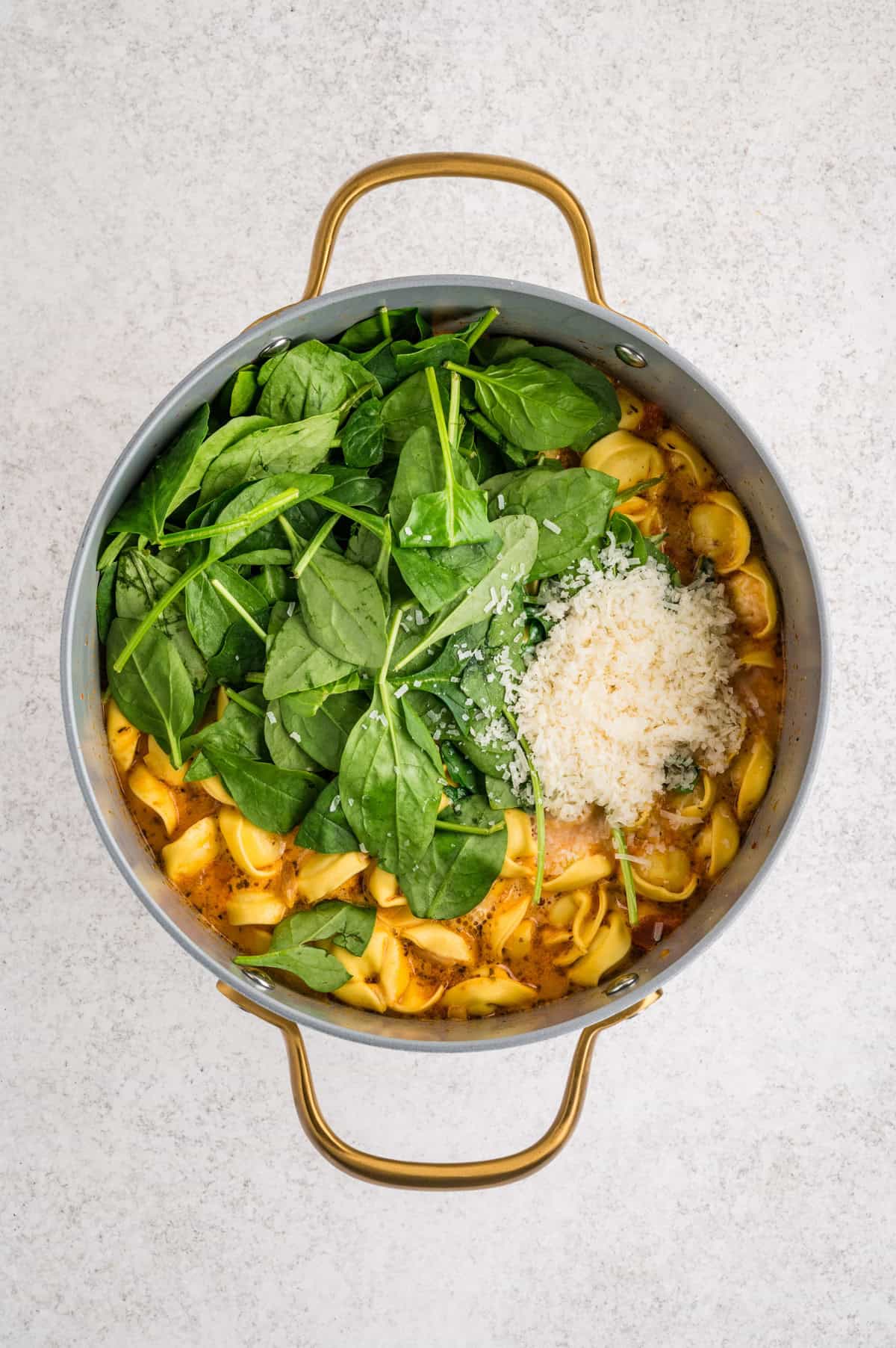 Creamy Tortellini Soup spinach in a pot