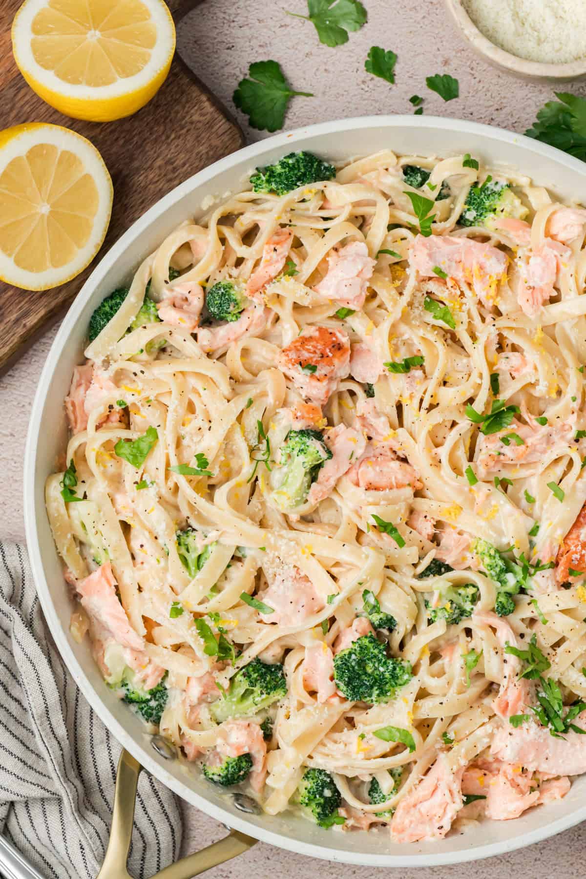 Creamy Alfredo Salmon Pasta served in a bowl with broccoli and Parmesan cheese