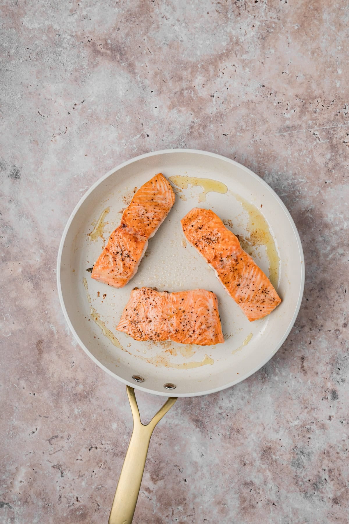 Salmon seared in a skillet