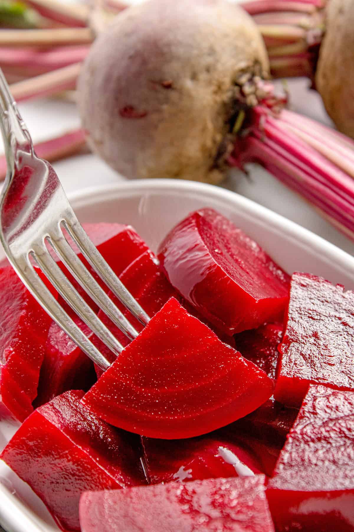 Fork piercing a pickled beet
