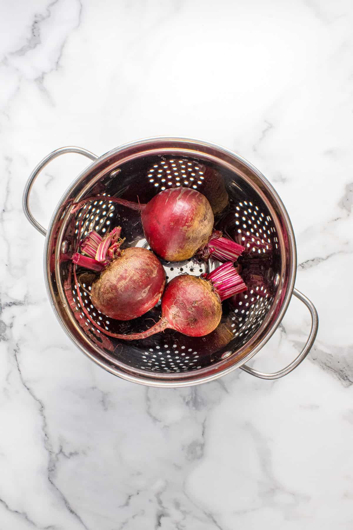 Beets being rinsed before brining