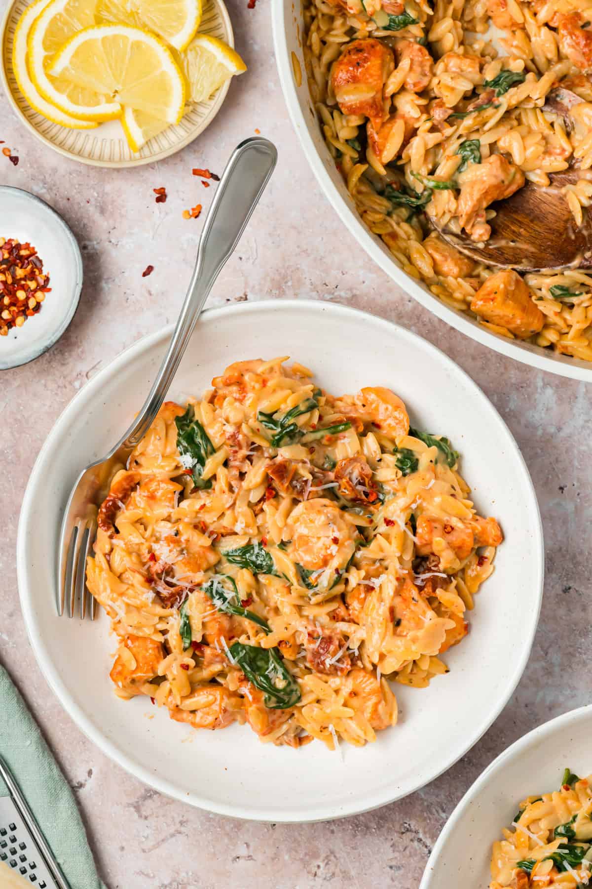 One pan marry me chicken orzo with sun-dried tomatoes and Parmesan cheese overhead view