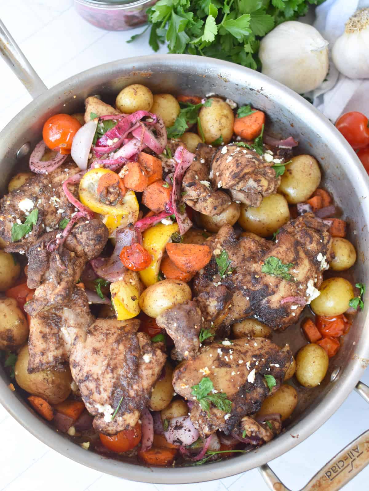 One pan Lebanese 7 spice chicken thighs with potatoes carrots and cherry tomatoes