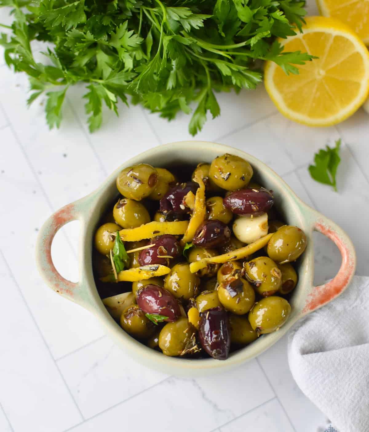 Bowl of warm Mediterranean olives with fresh parsley garnish