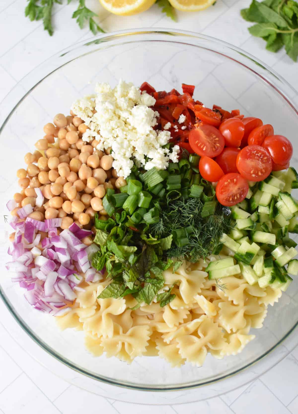 Bow Tie Pasta Salad ingredients in a glass bowl