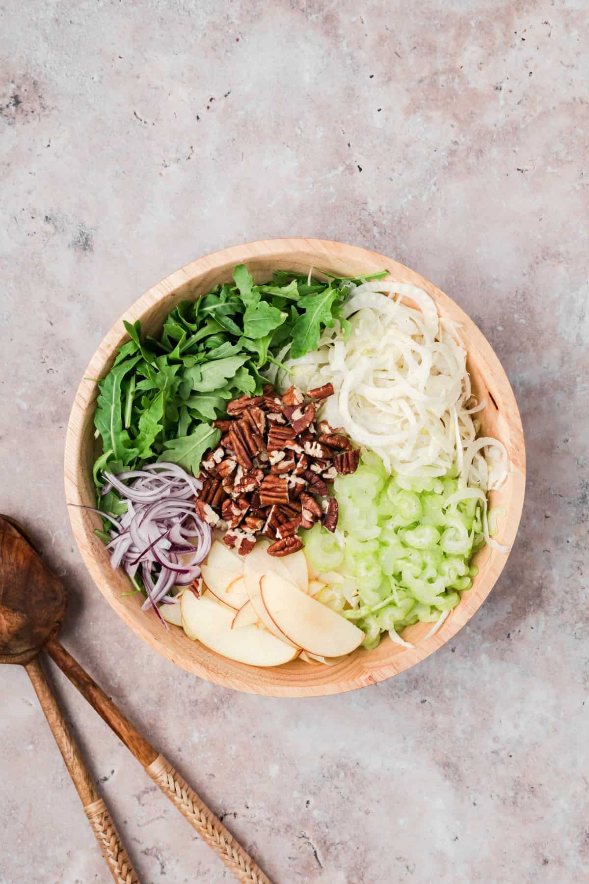 Easy Apple Fennel Salad mixing ingredients in a bowl