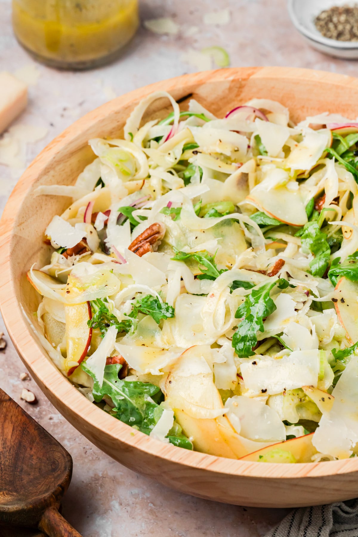 Overhead view of apple fennel salad with arugula, pecans, and Parmesan