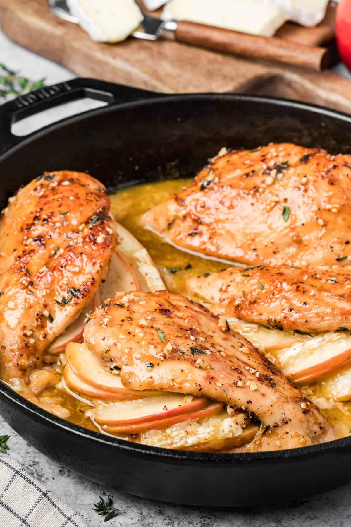 Close-up of melted Brie and apple filling inside baked stuffed chicken