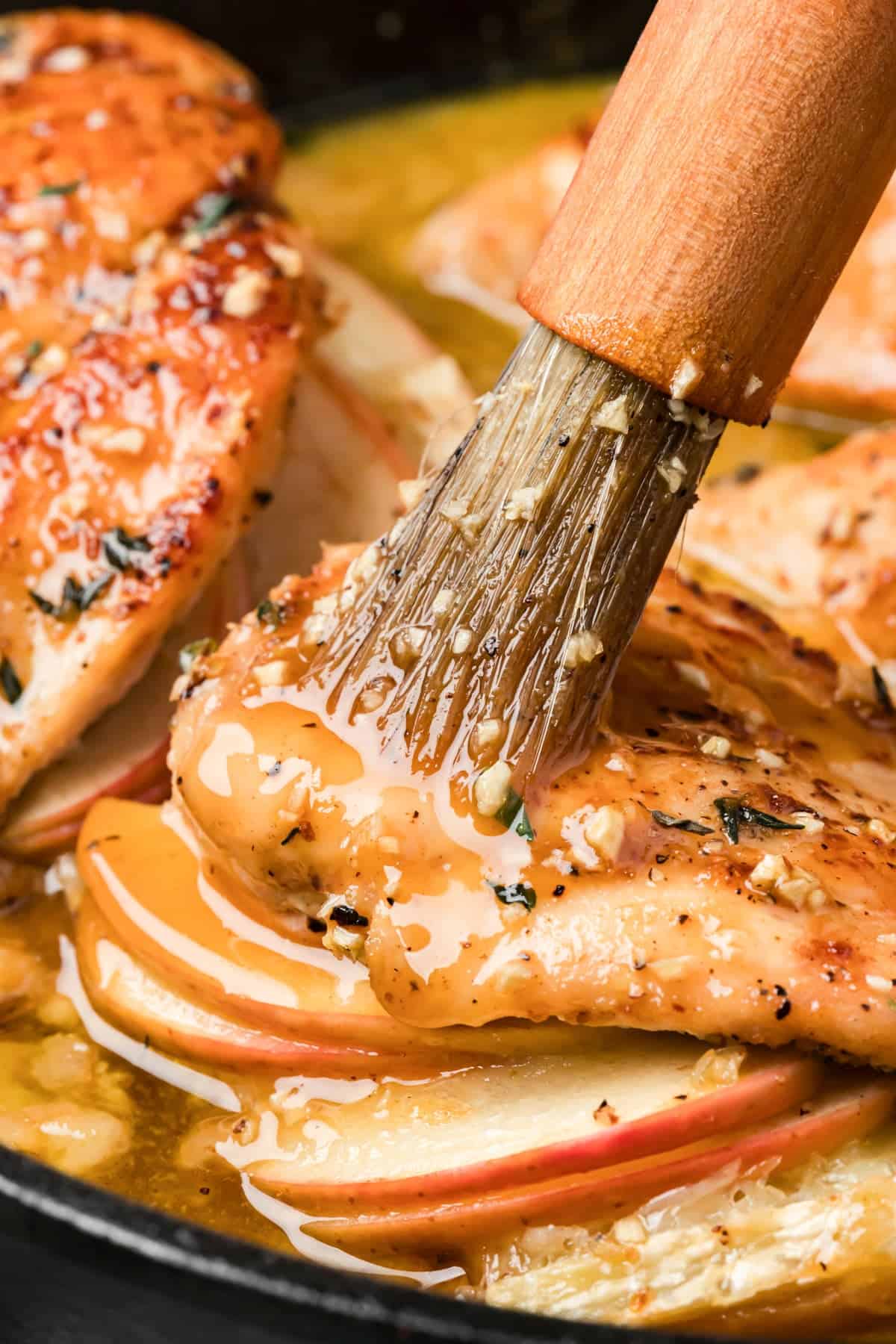 Brushing chicken with mpale glaze 