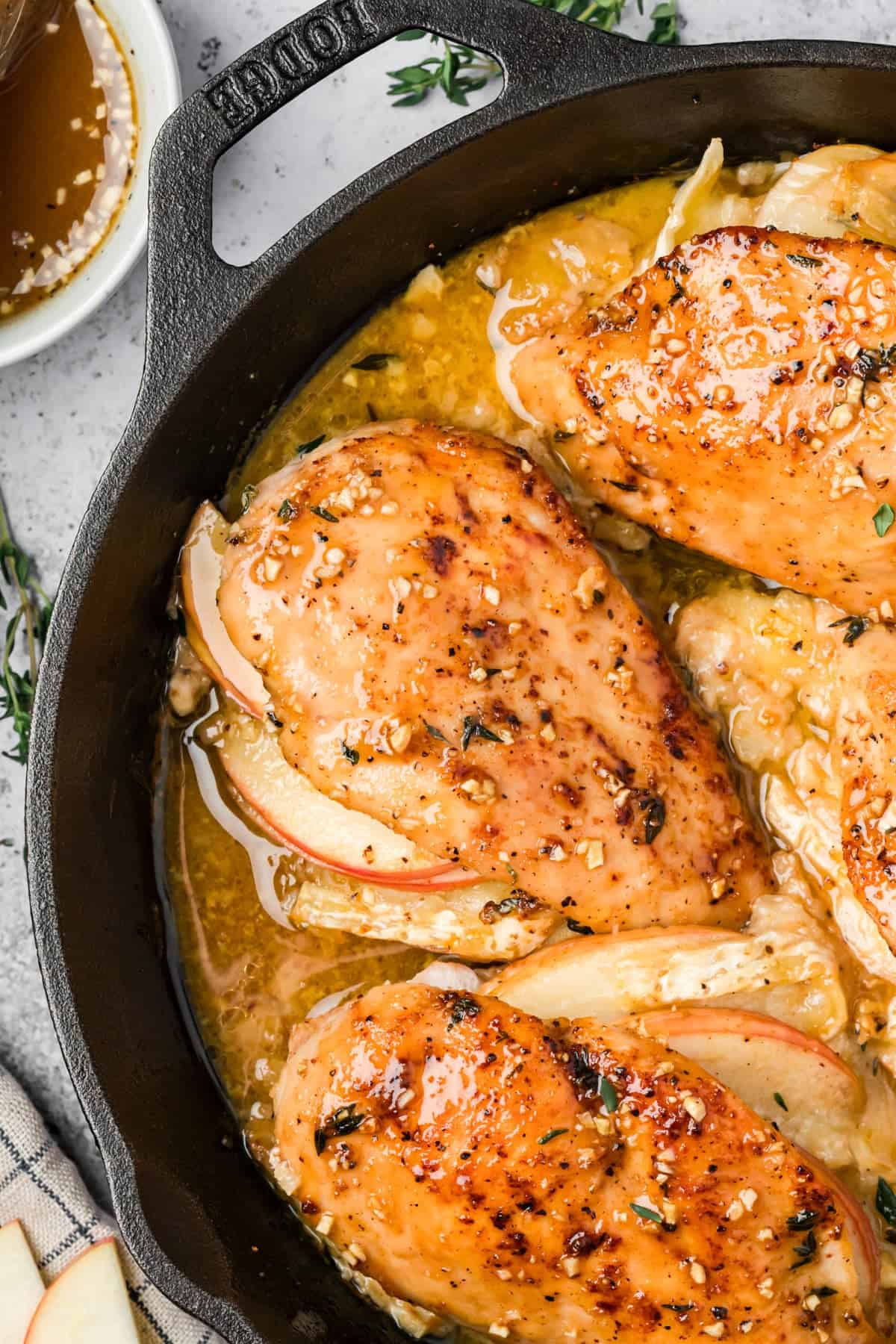 Apple and brie stuffed chicken cut open showing melted cheese and apple filling