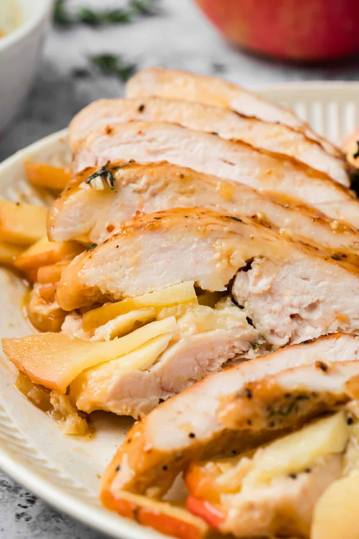 Sliced section of apple and brie stuffed chicken with maple Dijon glaze