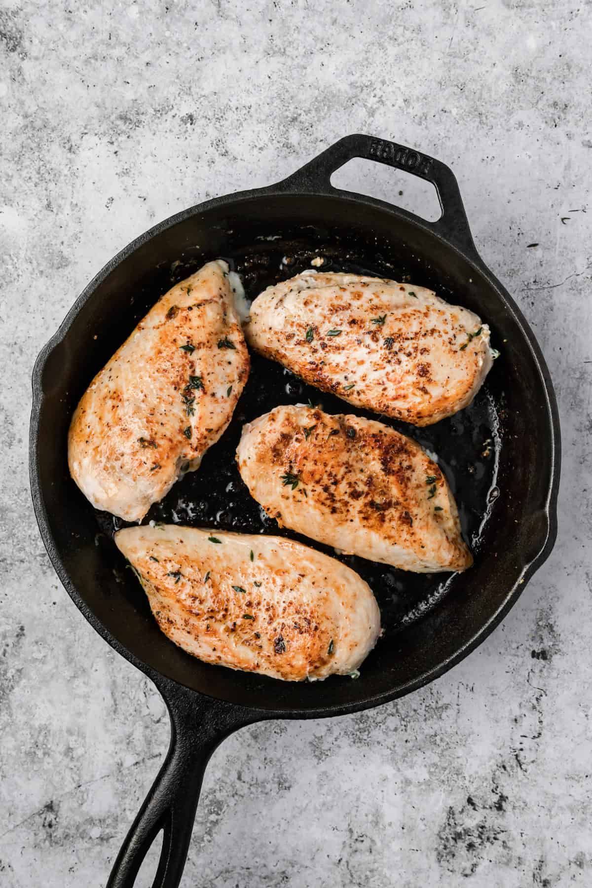 Apple Brie Stuffed Chicken searing in skillet 